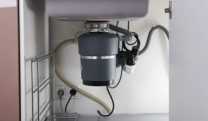 Installed garbage disposal unit Functional garbage disposal system after installation