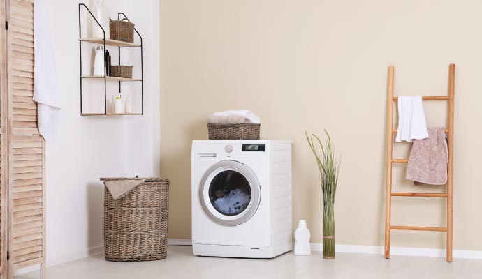 Washing machine installed in a residential laundry room Washing machine installed in a residential laundry room