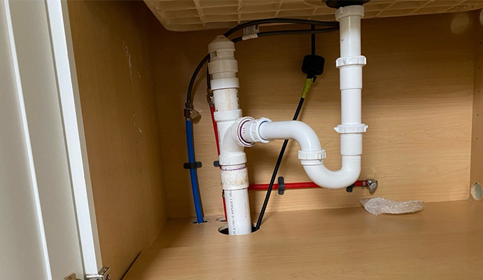 A professional repairing kitchen plumbing issue