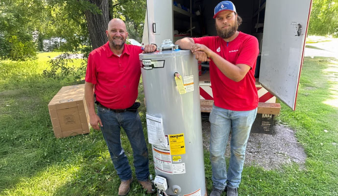 Professionals next to water heater