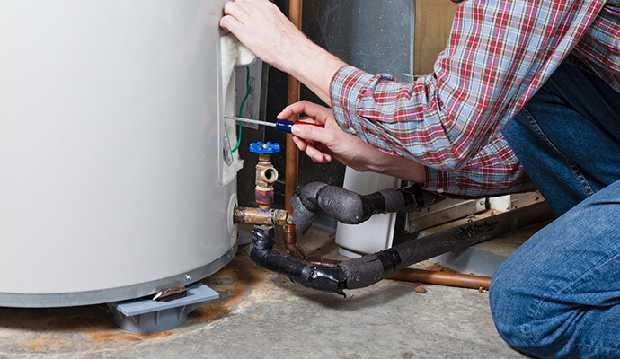 Person repairing a conventional water heater