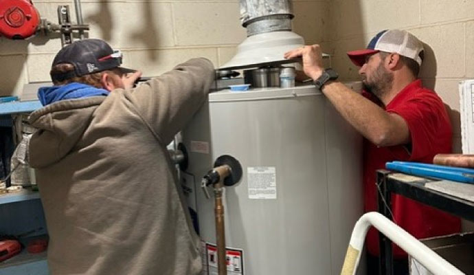 Professionals insulating water heater