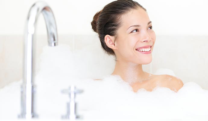 Happy woman taking shower